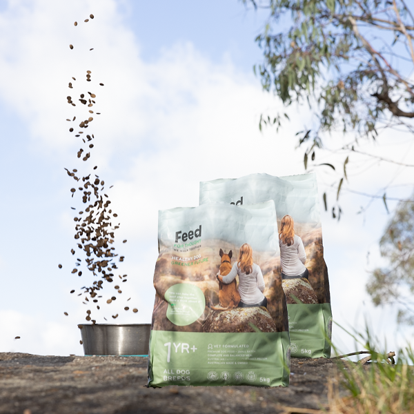 2 bags of Feed For Thought 5kg dog food bag outdoors with kibble pouring into a metal bowl, featuring a woman and dog on the packaging.