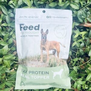 Feed For Thought's max protein meal topper sitting in a bed of vines